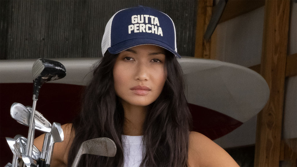 young woman wearing a gutta percha blue hat